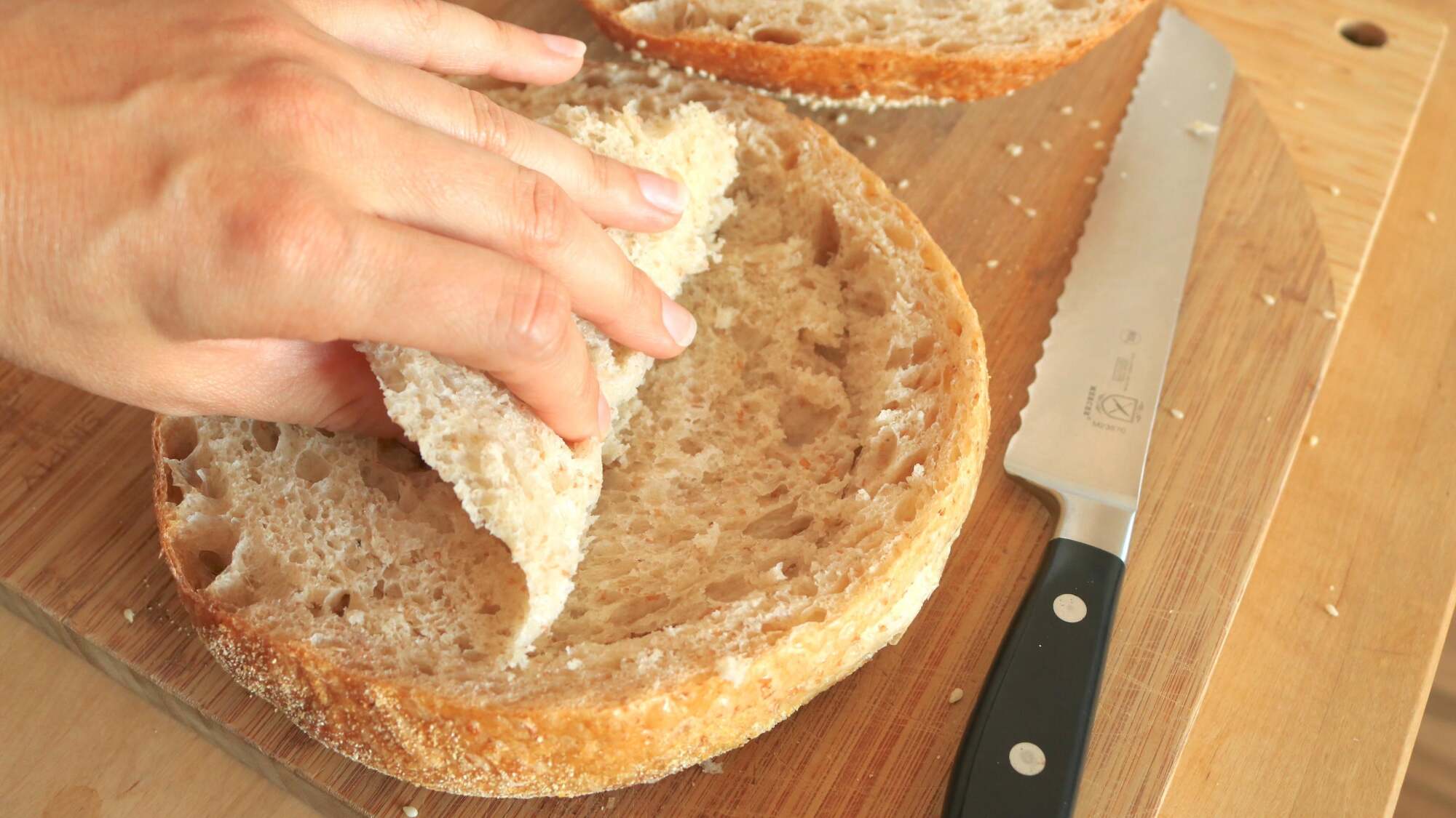 Loaf of bread split in half, the center of the crumb being removed