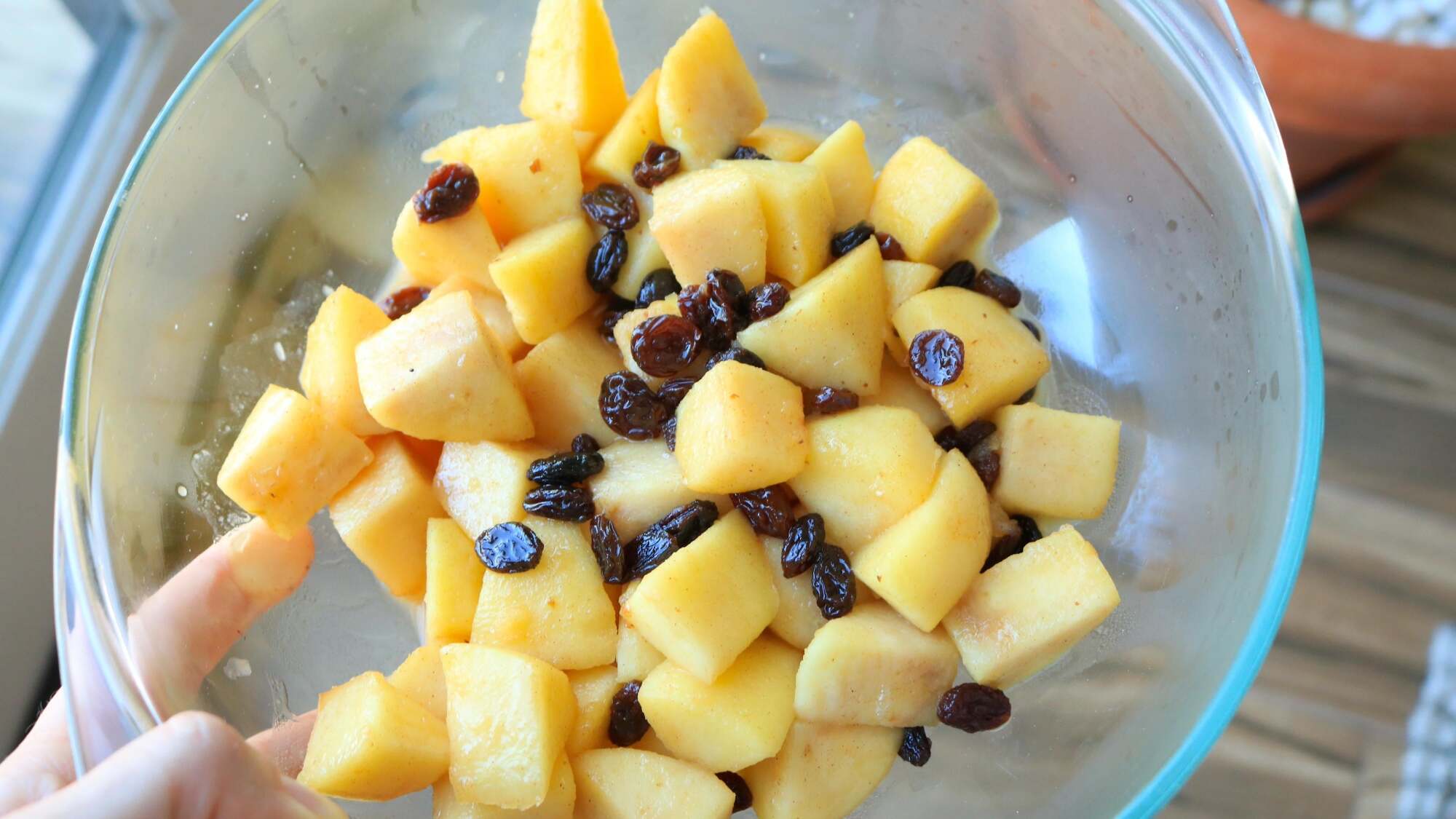 Apple chunks and raisins in a bowl.