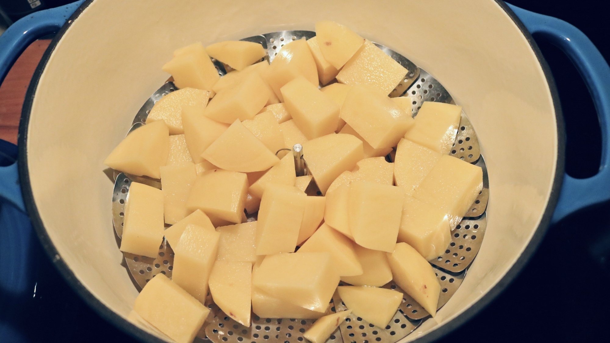 Chopped potatoes in a pot.