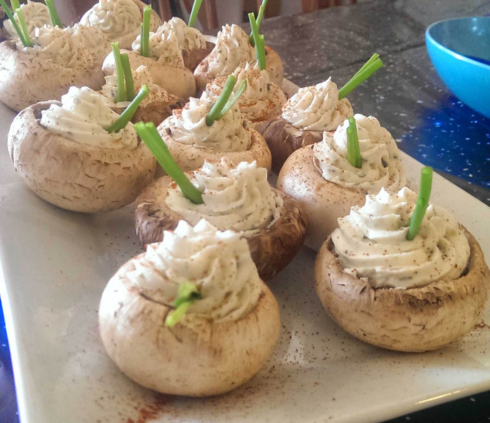 photo of stuffed mushrooms with chive blades at attention