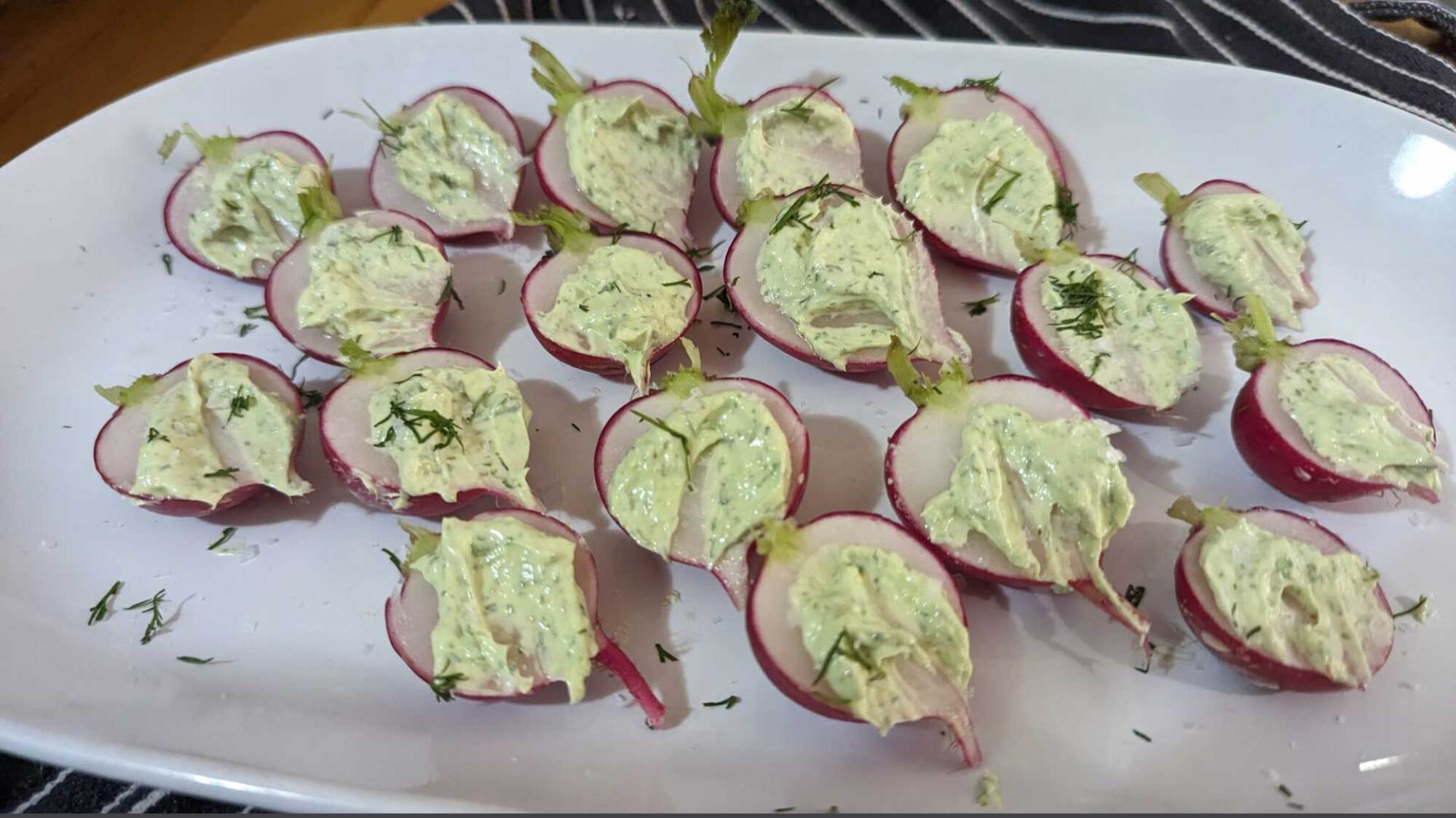 photograph of buttered radishes with sea salt and dill