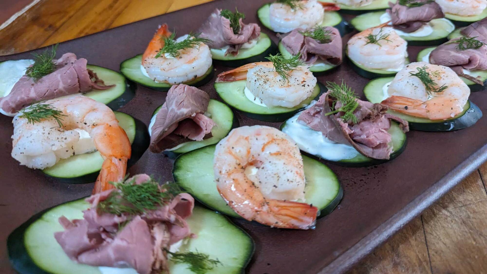 picture of shrimp and roast beef on cucumber cream rounds