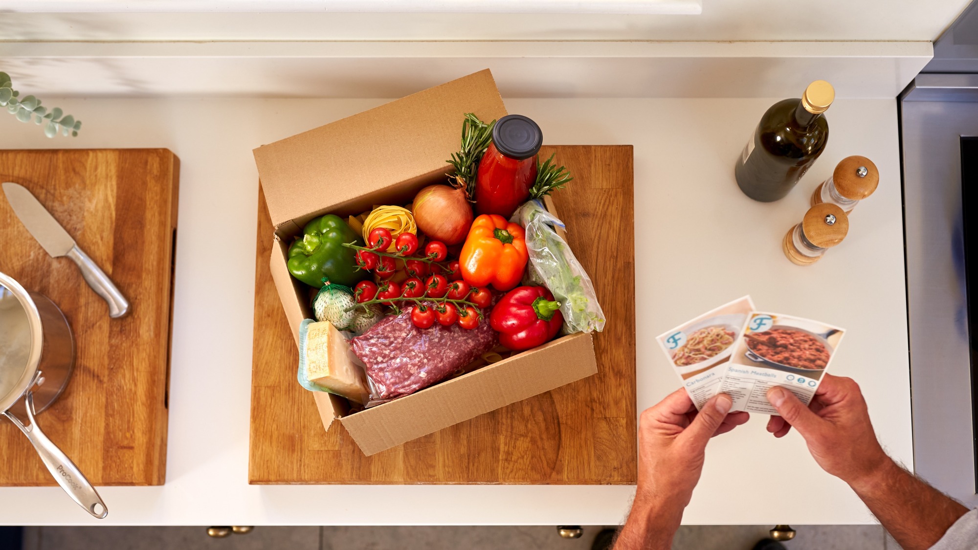 Box on a kitchen counter with food inside.