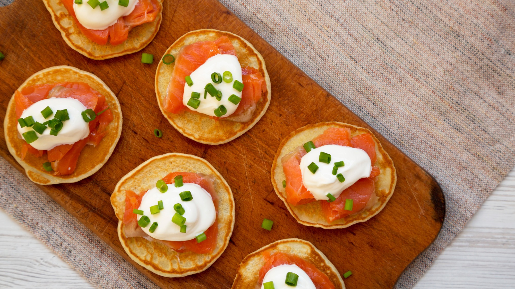 Salmon blinis on a cutting board