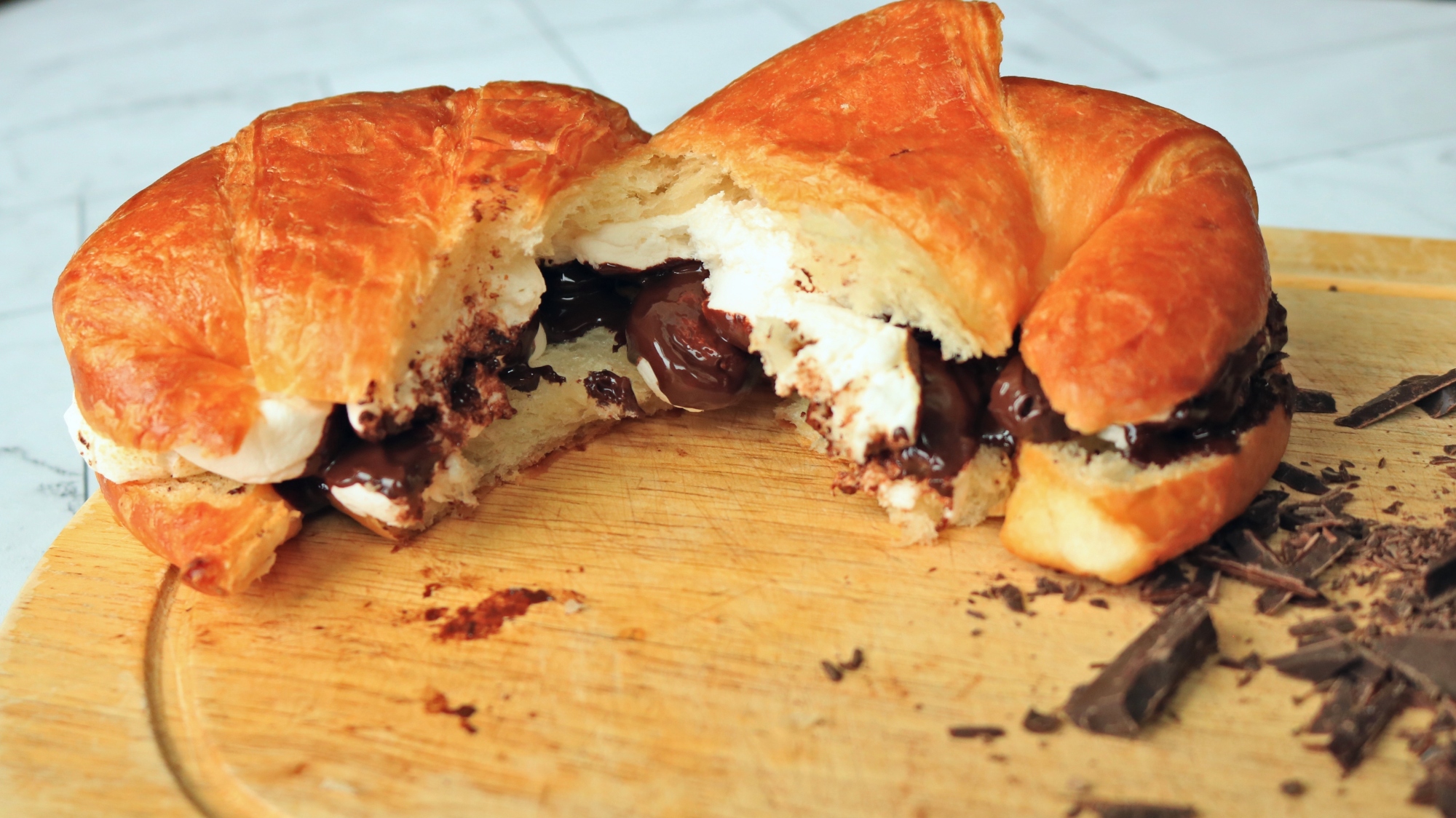 Croissant s'mores on a cutting board.