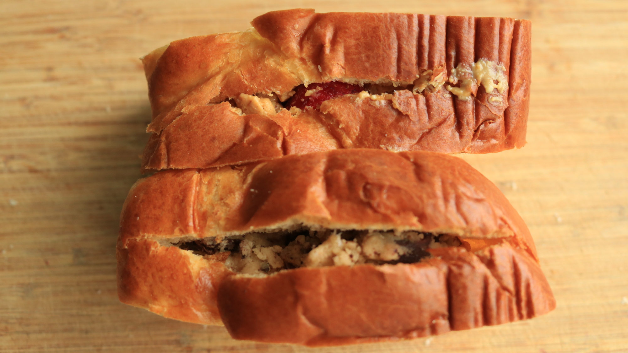 Two pieces of bread stuffed with different fillings.