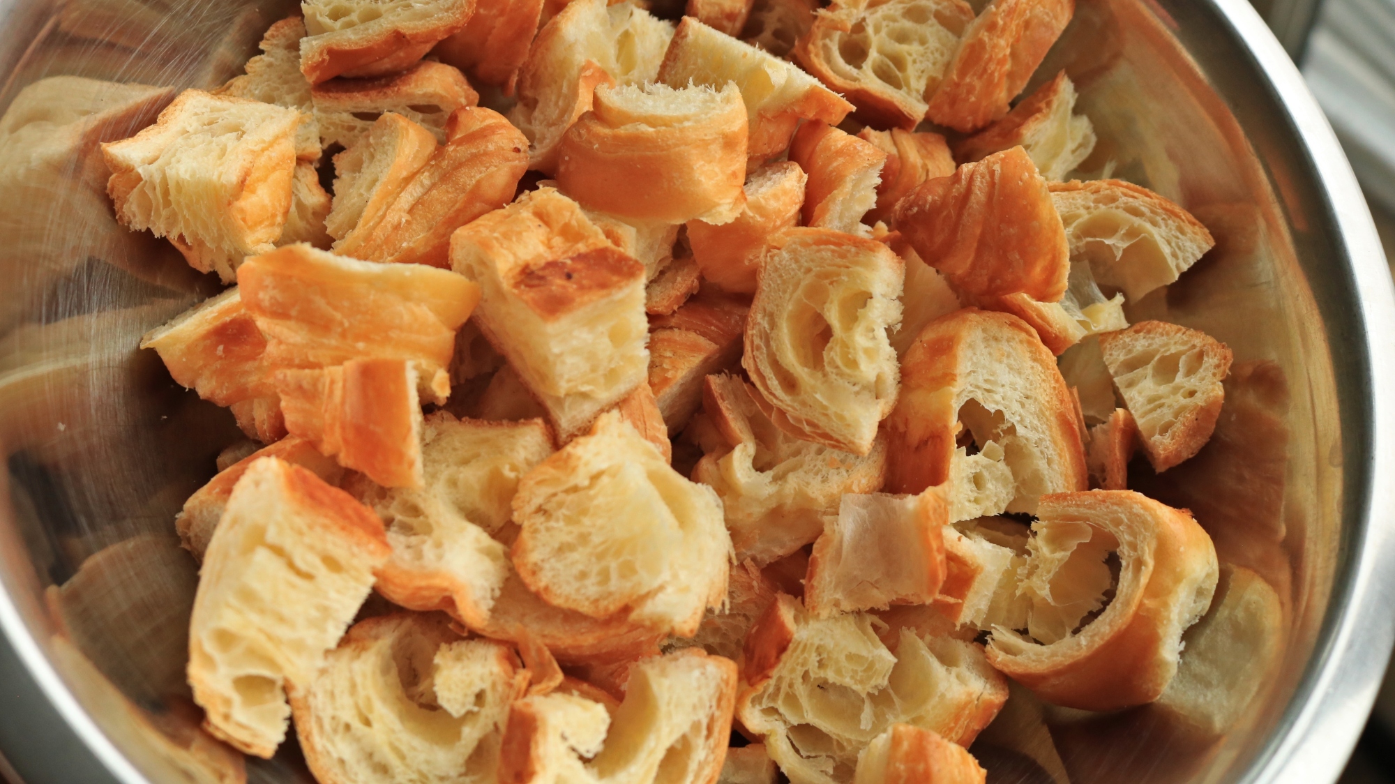 A bowl of cubed croissant pieces.