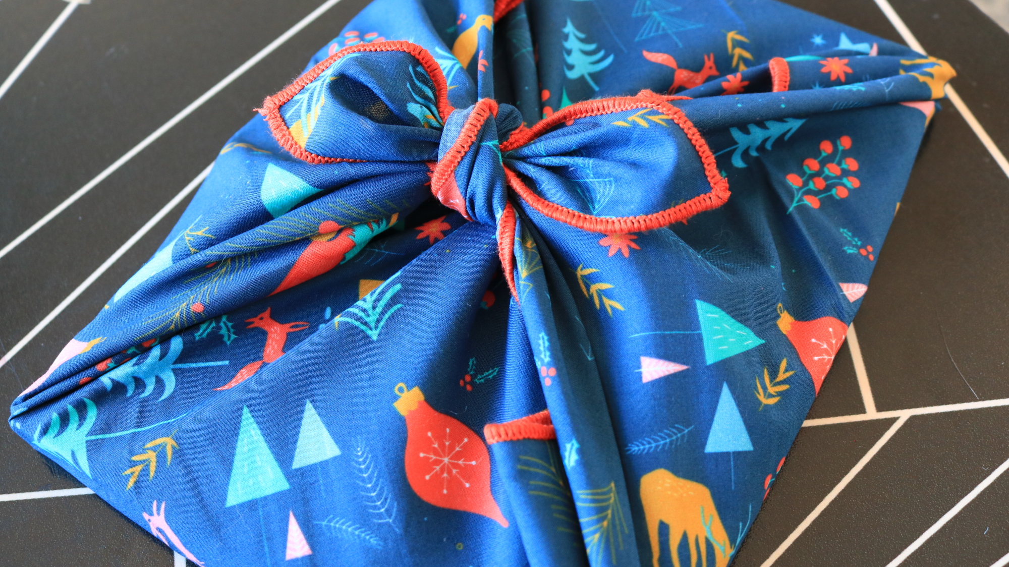 A gift wrapped in blue fabric.