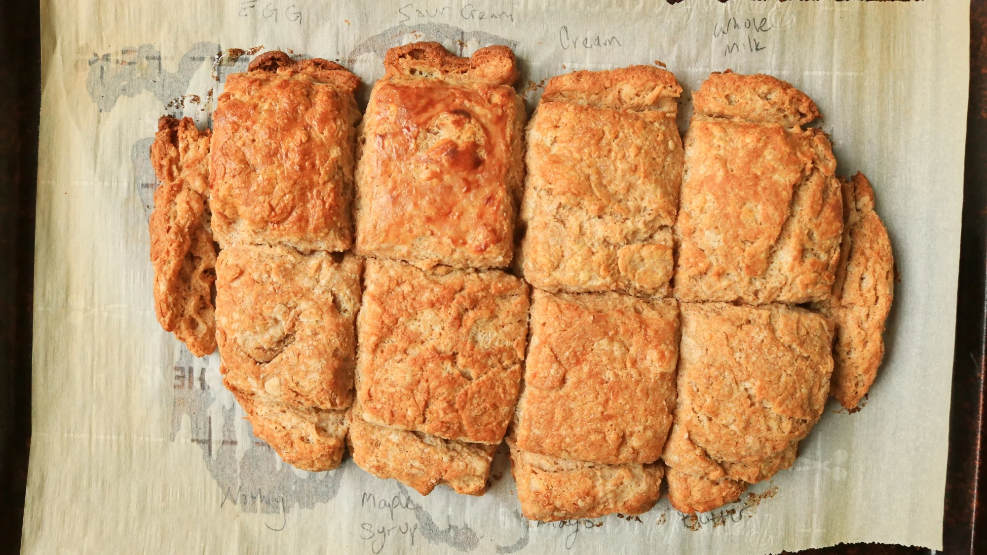 Baked bisuits on a sheet tray.