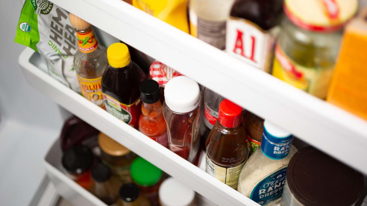 Banish condiments to a cooler to make room in the fridge